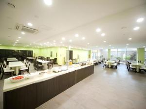 a large room with tables and chairs and a cafeteria at Sea View Hotel in Naedo-dong