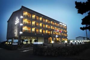 a large building with lights on in a parking lot at Sea View Hotel in Naedo-dong