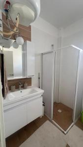 a bathroom with a shower and a sink at Caesar Resort Alexius in Bahçeler