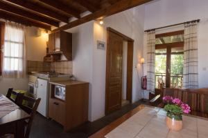 a kitchen with a table and a dining room at Proimos Maisonnettes in Platanias
