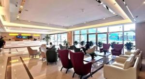 a lobby with chairs and tables in a building at GreenTree Inn Guiyang Wudang District High-speed Railway East Station in Jinzhuzhen