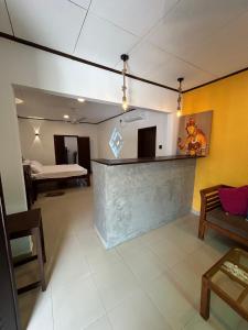 a living room with a bar and a bed at MJ Villa Ahangama in Ahangama