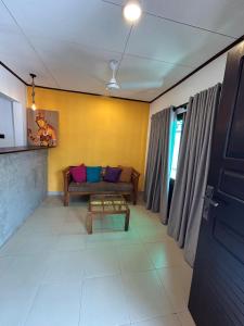 a living room with a couch and a table at MJ Villa Ahangama in Ahangama