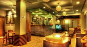 a bar in a restaurant with chairs and tables at Soledad Suites in Tagbilaran City