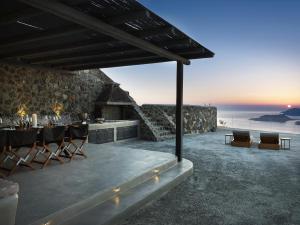 a restaurant with a table and a view of the ocean at Nafsika Estate in Megalokhori