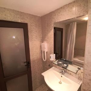 ein Badezimmer mit Waschbecken und Spiegel in der Unterkunft Ski view suite Emerald Bansko in Bansko
