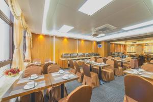 a conference room with tables and chairs in it at MeiQiu-Fino Hotel in Zhuhai