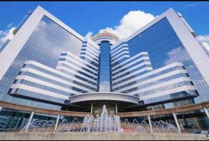 a large building with a fountain in front of it at Winnerway hotel in Dongguan