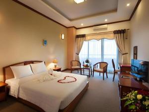 a hotel room with a bed and a television at CWD Hotel in Hanoi +66 photos