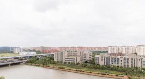 a city with a river and buildings and a bridge at New century Manju Select Hotel Hongqiao Hub National Exhibition Center in Shanghai