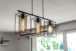 a chandelier hanging from a ceiling in a room at Bright Apartment Near the lake in Bordeaux +11 photos