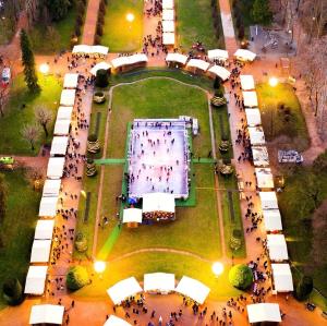 a crowd of people standing around a park at night at La Portesina Mantova in Mantova