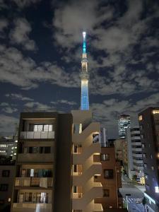 a tower with a blue light on top of it at Tower View Stay Kinchicho in Wada