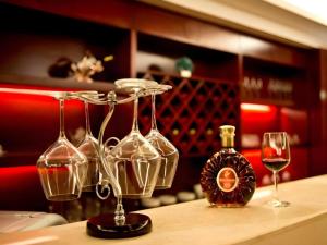 a group of wine glasses and a bottle on a table at Wuhan Zall Royal Hotel- North Hankou International Hotel in Wuhan