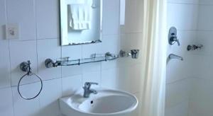 a bathroom with a sink and a mirror and a shower at Hotel Norbu Sangpo in Kathmandu