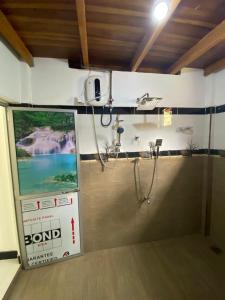 a view of a room with a large flat screen tv at Diyaluma Villa Resort in Koslanda +26 photos