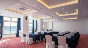 a large room with a bunch of tables and chairs at Oneness Resort in Wando