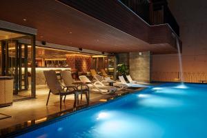a pool with chairs and a bar in a building at Champton Nha Trang Hotel in Nha Trang +127 photos