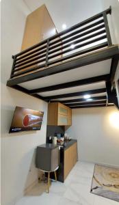 a room with a kitchen with a loft at The W Residence in Jakarta