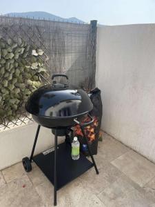 a bbq grill sitting next to a wall at Bord de mer in Sainte-Maxime +3 photos