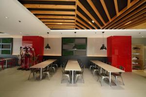 a restaurant with tables and chairs and red cabinets at Majestic Hotel Manila - Formerly Octagon Mansion Hotel Manila in Manila