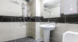 a bathroom with a sink and a shower at Dubai Motel in Daejeon +45 photos