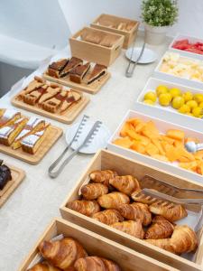 a table topped with different types of pastries and bread at Hotel Il Girasole in Anacapri +43 photos