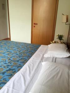 Postel nebo postele na pokoji v ubytování Hotel Altavilla Dieci