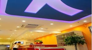 a woman standing at a counter in a store at 7 Days Inn Beijing Zhongguancun Suzhouqiao in Beijing