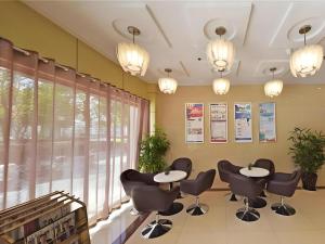 a waiting room with chairs and tables and a window at GreenTree Alliance Jiangsu Yangzhou Hanjiang Middle Road Libao Square Hotel in Yangzhou