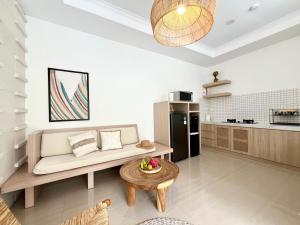a living room with a couch and a table at Villa Kelle - Uluwatu Nusa Dua in Nusa Dua