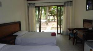 a bedroom with two beds and a desk and a window at Jinta Hotel Nathon Beach in Nathon +110 photos