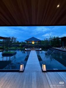 a swimming pool with a gazebo with lights on it at Terra Art Hotel in Chengdu