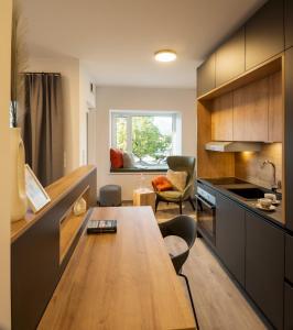 a kitchen with a wooden table in a room at Sattler Living Apartments in Ebbs
