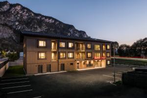 a large building with a mountain in the background at Sattler Living Apartments in Ebbs