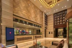 a living room with a tv in a building at New Century Manju Hotel Shanghai New International Expo Center in Shanghai