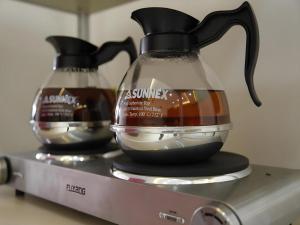 two glass vases sitting on top of a machine at Beijing Yi Jia Hotel in Beijing