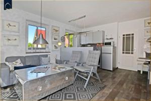 a living room with a couch and a table at Waldsiedlung DHH Waldhaus 6 in Korswandt +37 photos