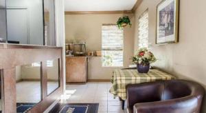 a kitchen with a table with a table cloth and a chair at Rodeway Inn Allentown South in Allentown