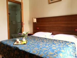 Postel nebo postele na pokoji v ubytování Hotel Altavilla Dieci