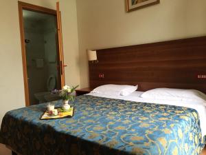 Postel nebo postele na pokoji v ubytování Hotel Altavilla Dieci