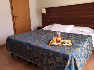 Postel nebo postele na pokoji v ubytování Hotel Altavilla Dieci