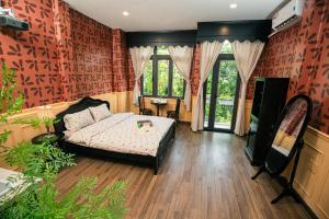 a living room with a bed and a television at Nàng Homestay Studio in Thu Dau Mot +83 photos