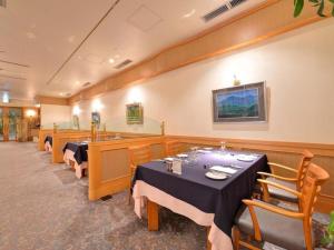 a dining room with tables and chairs in a restaurant at Hotel Takeshima in Gamagori +163 photos