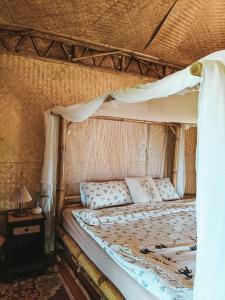 a bed with a canopy in a room at Yidan Farmstay in Chiang Dao in Ban Mae Khon