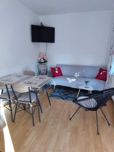 a living room with a couch and a table and chairs at Apartman NADA in Krapina +28 photos
