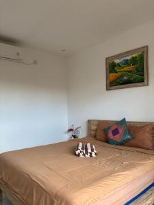 a bed with two stuffed animals on top of it at Ika Homestay 2 in Canggu