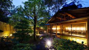 a house with a swimming pool at night at Hotel Masyuu in Shibata