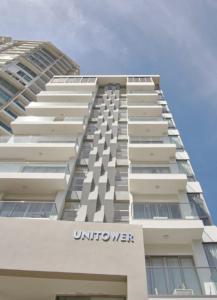 a tall white building with the words unuterwer at Apartments in La Julia 1 and 2 Bedrooms in Santo Domingo