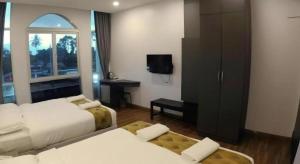 a hotel room with two beds and a television at HOTEL KAWAN BIDOR in Bidur